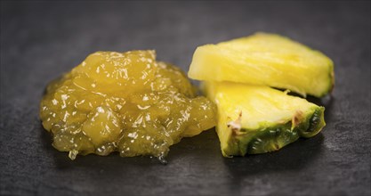 Portion of Pineapple Jam on a rustic slate slab, selective focus, close-up shot