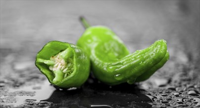 Portion of Raw Pimientos on a rustic slate slab, selective focus, close-up shot