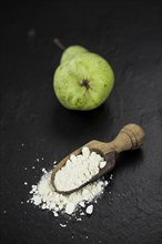 Portion of fresh made Pear powder on a slate slab (selective focus)