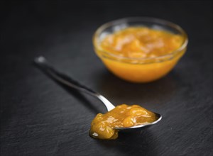 Fresh made Apricot Jam on a vintage background (close-up shot)