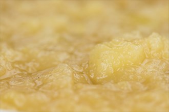 Portion of homemade Applesauce (selective focus, close-up shot) on vintage background