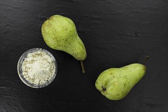 Portion of fresh made Pear powder on a slate slab (selective focus)
