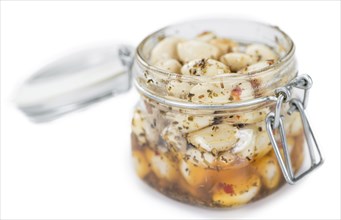 Portion of Preserved Garlic (as close-up shot) isolated on white background