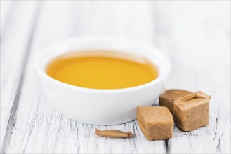 Caramel Sirup on a vintage background as detailed close-up shot (selective focus)