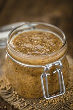 Fresh made German Cuisine (sweet Mustard) on a vintage background (close-up shot)