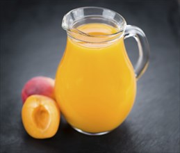 Apricot Juice on a vintage slate slab (close-up shot, selective focus)