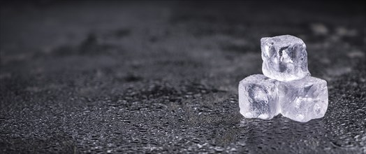 Some melting Ice cubes on a vintage slate slab (selective focus)