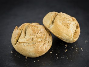 Some fresh German Rolls on a vintage slate slab, selective focus, close-up shot