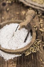 Vintage wooden table with Oat Flour (selective focus, close-up shot)