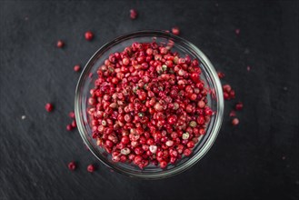 Pink Peppercorns on a vintage background as detailed close-up shot, selective focus