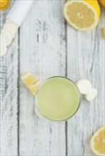 Vitamin C Tablets as high detailed close-up shot on a vintage wooden table, selective focus