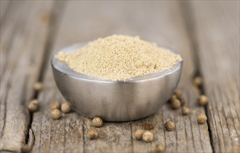 White Pepper on rustic wooden background as close-up shot