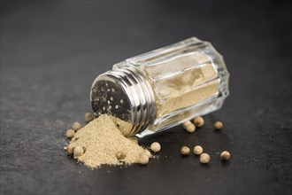 Portion of White Pepper on a rustic slate slab, selective focus, close-up shot