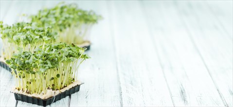 Portion of homemade Cress on wooden background (selective focus, close-up shot)