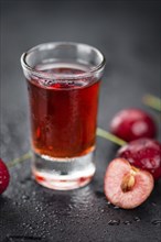 Homemade Cherry Liqueur on vintage background selective focus, close-up shot