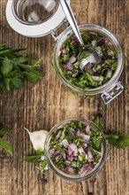 Fresh Homemade Chimichurri as detailed close-up shot (selective focus)