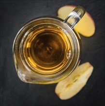 Fresh made Apple Cider on a vintage background (close-up shot)