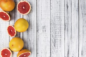 Chopped Grapefruits (selective focus) on a vintage background as detailed close-up shot