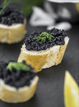 Caviar on a vintage looking slate slab (selective focus)