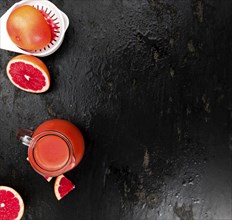 Slate slab with freshly squeezed Grapefruit Juice (selective focus, close-up shot)