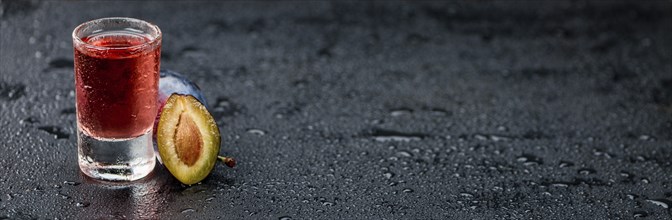 Plum Liqueur on a vintage slate slab as detailed close-up shot, selective focus