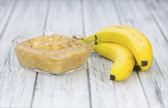 Mashed Bananas (selective focus, close-up shot) on a vintage background