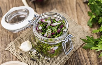 Fresh Homemade Chimichurri as detailed close-up shot (selective focus)