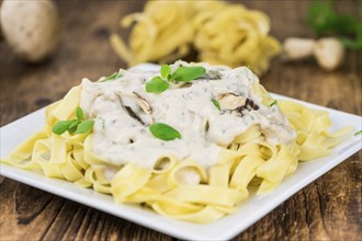 Porcini pasta on an old wooden table as detailed close-up shot, selective focus