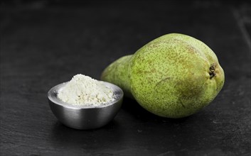 Portion of fresh made Pear powder on a slate slab (selective focus)