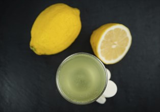 Portion of Vitamin C Tablets as detailed close up shot on a slate slab, selective focus