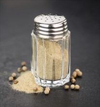 Portion of White Pepper on a rustic slate slab, selective focus, close-up shot