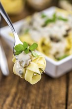 Porcini pasta on a vintage background as detailed close-up shot, selective focus