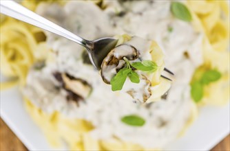 Porcini pasta on an old wooden table as detailed close-up shot, selective focus