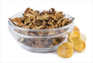 Portion of Dried Chanterelles as detailed close-up shot isolated on white background