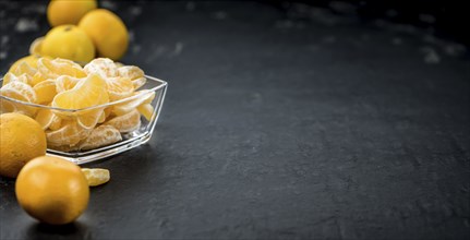 Raw Tangerine pieces (close-up shot) on vintage background