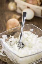 Diced white onions on a vintage background as detailed close-up shot, selective focus