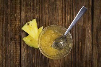 Fresh made Pineapple Jam on an old and rustic wooden table, selective focus, close-up shot