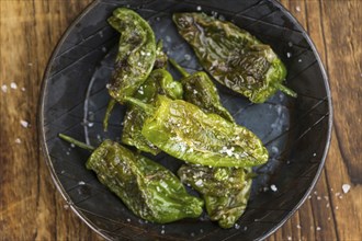 Portion of fresh Pimientos de Padron close-up shot, selective focus