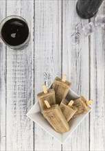 Cola Popsicles (selective focus) on a vintage background as detailed close-up shot