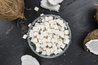 Portion of healthy Coconut dices (selective focus, close-up shot)