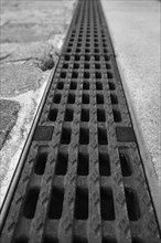 View over an iron grate, blurred background, black and white, Cologne, Germany, Europe