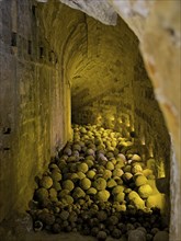 Historical vaulted corridor today illuminated with yellow light inside old stone bullets stones