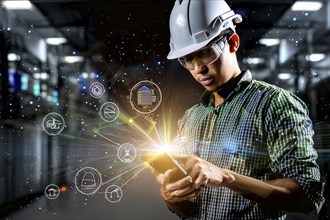 Worker with hard hat and tablet, surrounded by holographic symbols, standing in an industrial