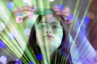 A woman in safety goggles works intently with green light and laser effects, AI and illustration