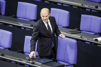 Federal Chancellor Olaf Scholz arrives at a session of the Bundestag to make a government