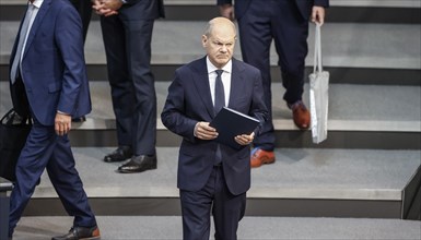 Federal Chancellor Olaf Scholz arrives at a session of the Bundestag to make a government