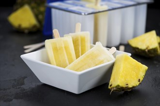 A rustic slate slab with homemade Popsicles (selective focus, close-up shot)