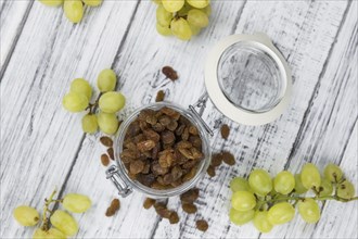 Vintage wooden table with Raisins (selective focus, close-up shot)