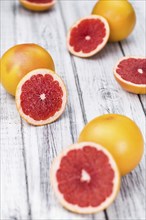 Chopped Grapefruits (selective focus) on a vintage background as detailed close-up shot