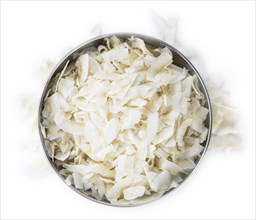 Portion of Coconut Chips isolated on white background (selective focus)